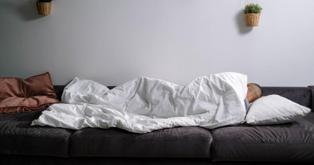 A person sleeping on the best sofa beds